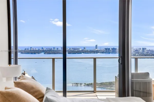 a living room with furniture and a floor to ceiling window