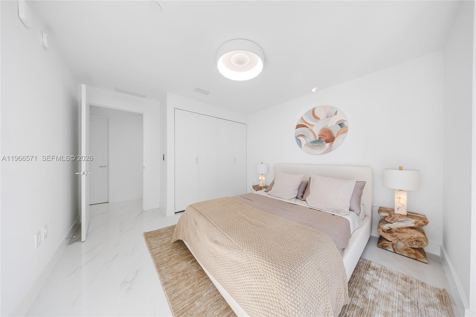 700 Northeast 24th Street, Unit 4007 Miami, FL 33137 - Photo 48 of 100 a bedroom with a bed and a painting on the wall