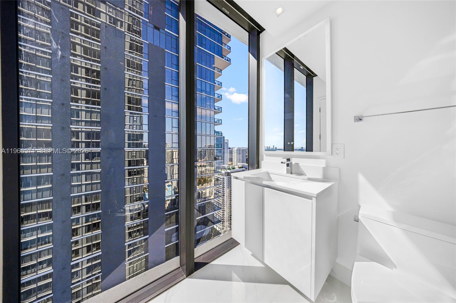700 Northeast 24th Street, Unit 4007 Miami, FL 33137 - Photo 50 of 100 a bathroom with a double vanity sink a toilet and shower