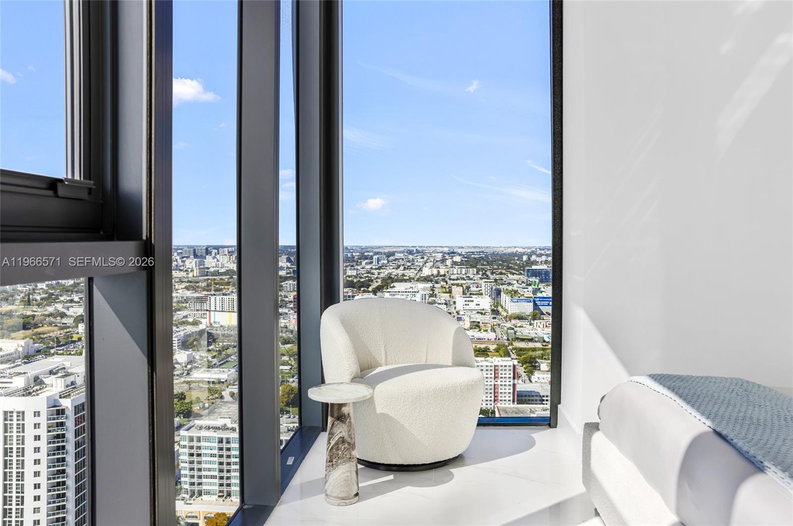 700 Northeast 24th Street, Unit 4007 Miami, FL 33137 - Photo 56 of 100 a living room with furniture and a floor to ceiling window