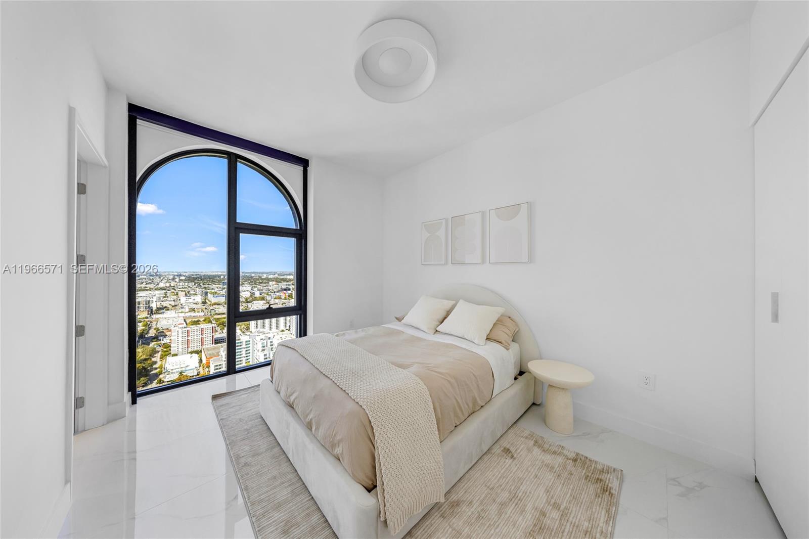 700 Northeast 24th Street, Unit 4007 Miami, FL 33137 - Photo 59 of 100 a bedroom with a bed and a large window