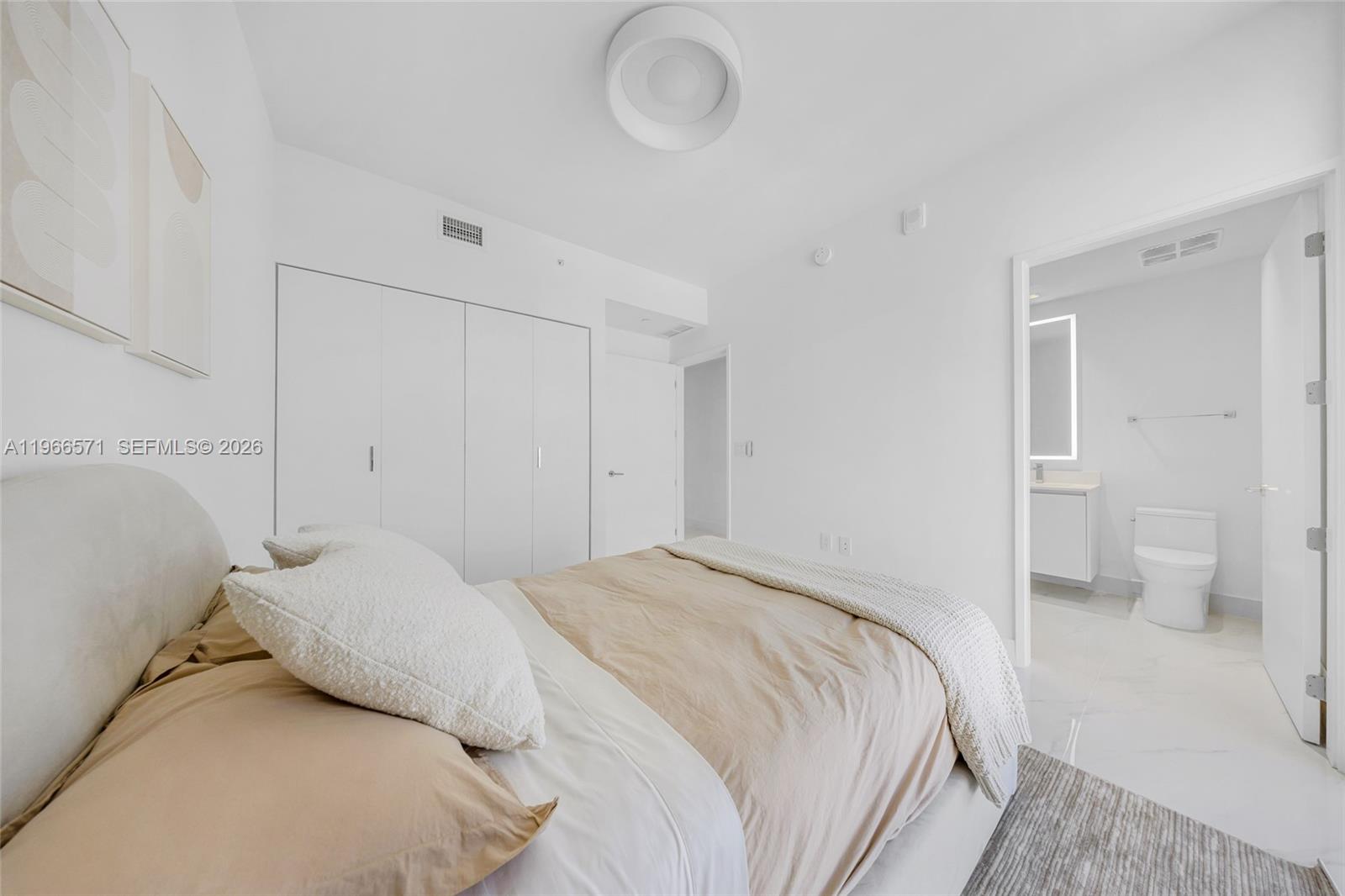 700 Northeast 24th Street, Unit 4007 Miami, FL 33137 - Photo 62 of 100 a bedroom with a bed and toilet