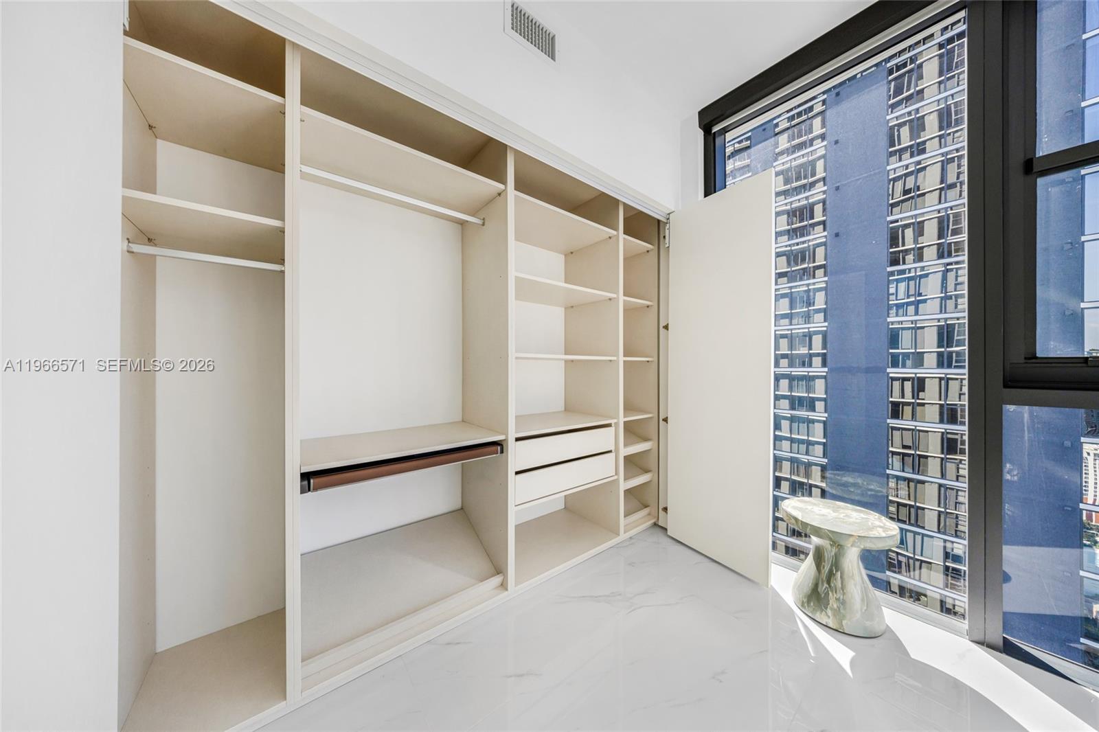 700 Northeast 24th Street, Unit 4007 Miami, FL 33137 - Photo 64 of 100 a view of walk in closet with empty racks