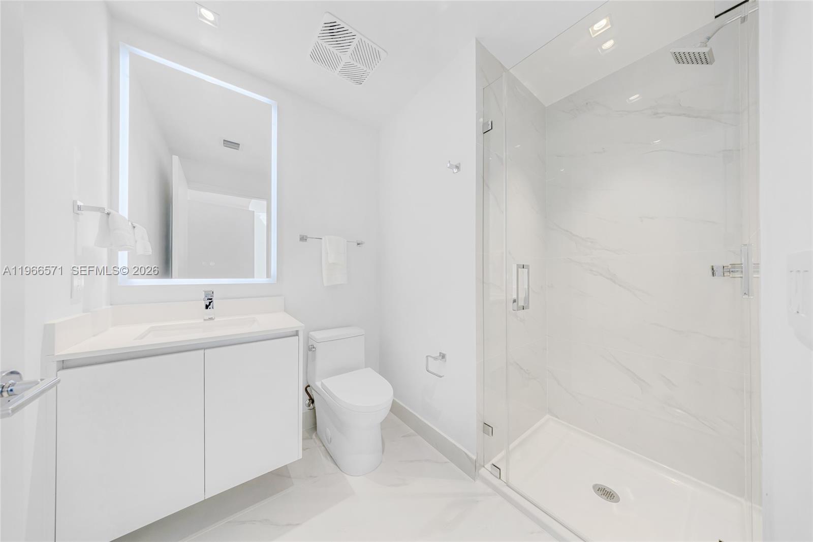 700 Northeast 24th Street, Unit 4007 Miami, FL 33137 - Photo 66 of 100 a bathroom with a bathtub shower sink vanity and toilet