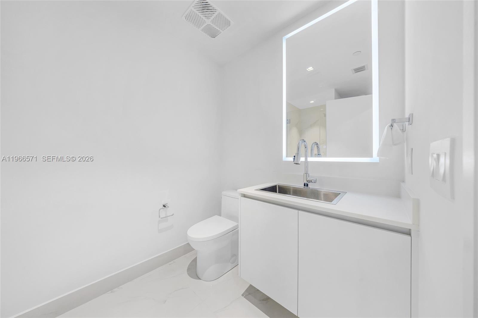 700 Northeast 24th Street, Unit 4007 Miami, FL 33137 - Photo 67 of 100 a bathroom with a sink and a toilet