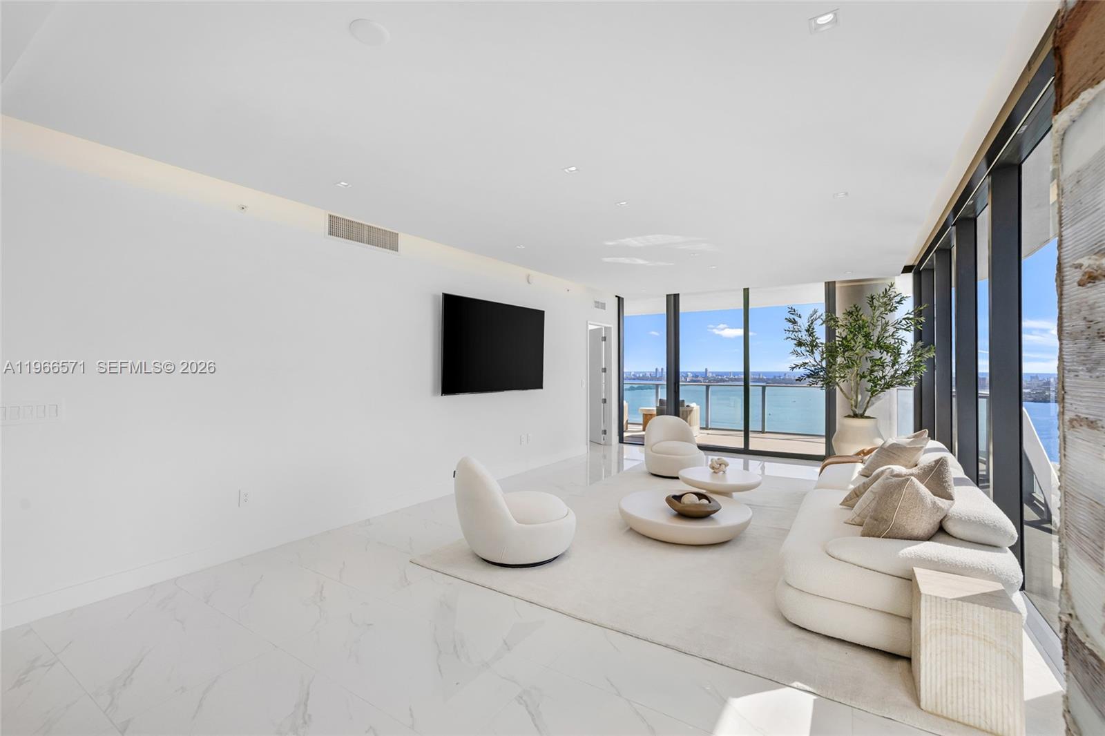 700 Northeast 24th Street, Unit 4007 Miami, FL 33137 - Photo 10 of 100 a living room with furniture and a flat screen tv