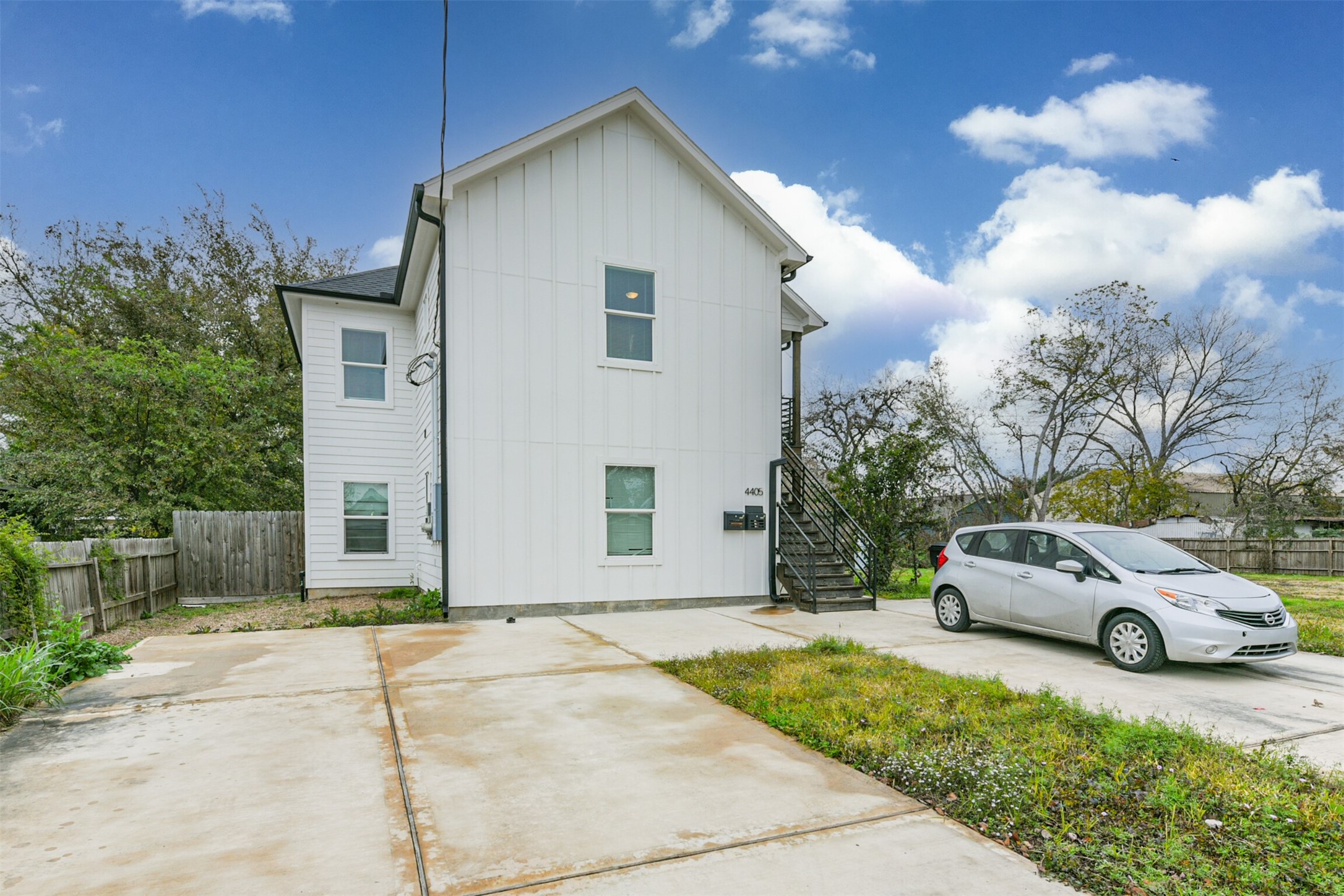 4405 Mallow Street Houston, TX 77051 - Photo 17 of 21 a white house with a yard and parking space