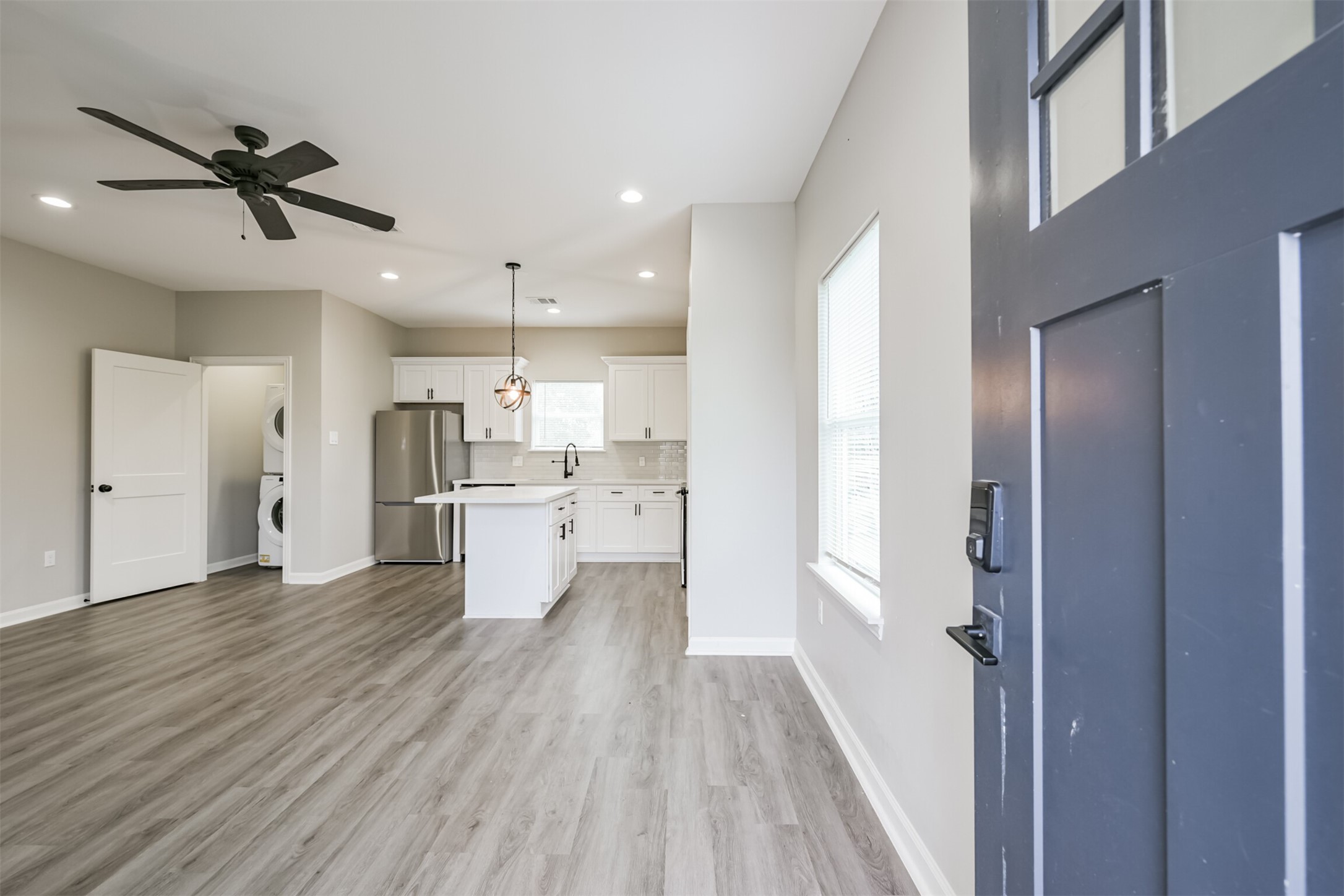 a view of a kitchen with a sink and wooden floor