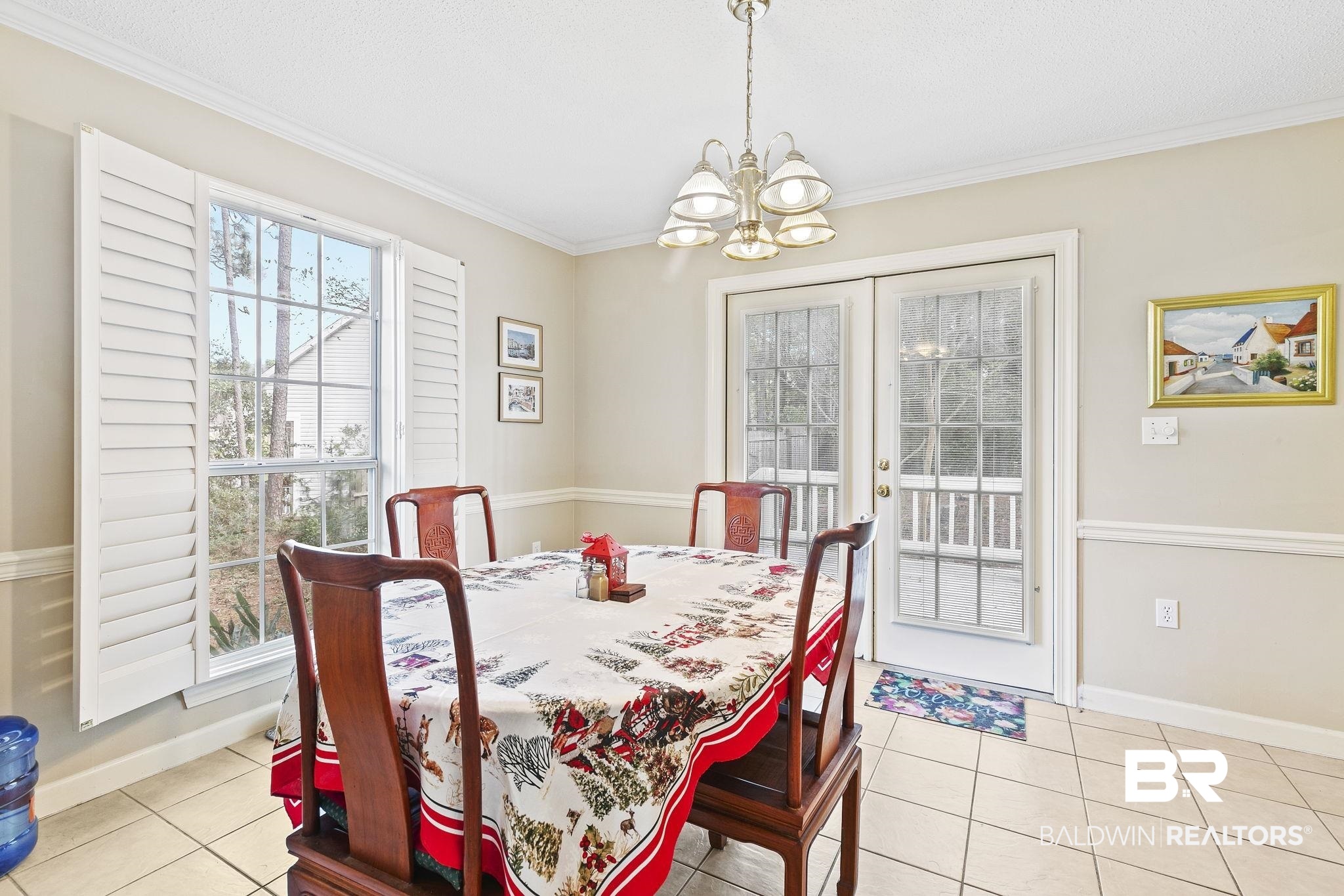 22 Pirates Lane Daphne, AL 36527 - Photo 15 of 36 Tiled dining room with ornamental molding and a notable chandelier
