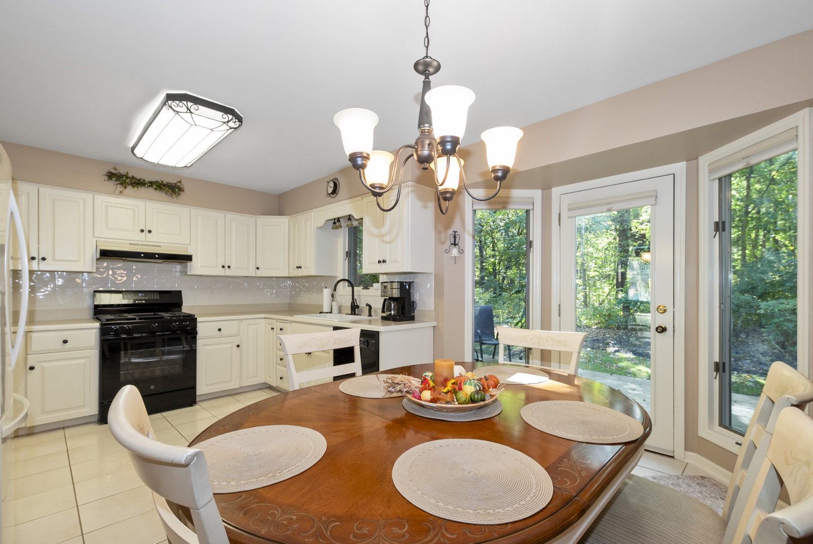 9051 Archer Avenue Willow Springs, IL 60480 - Photo 11 of 30 a dining room with wooden floor a chandelier a wooden table and chairs