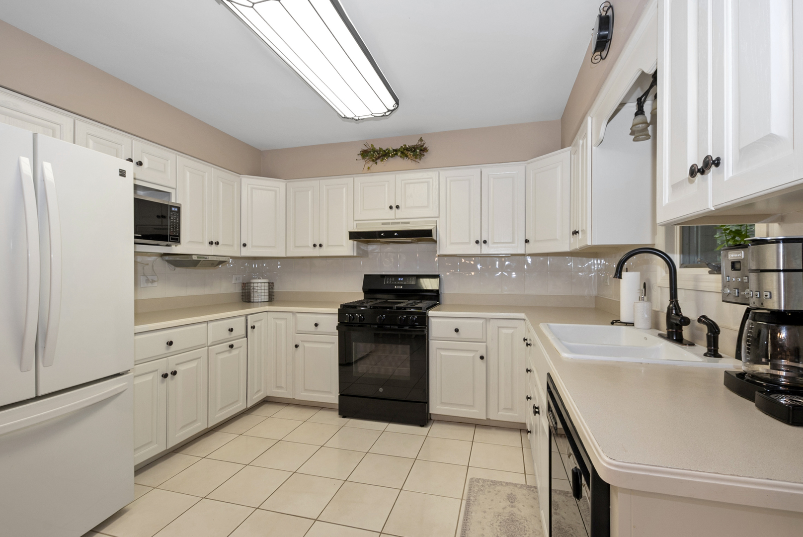 9051 Archer Avenue Willow Springs, IL 60480 - Photo 12 of 30 a kitchen with granite countertop white cabinets and white appliances