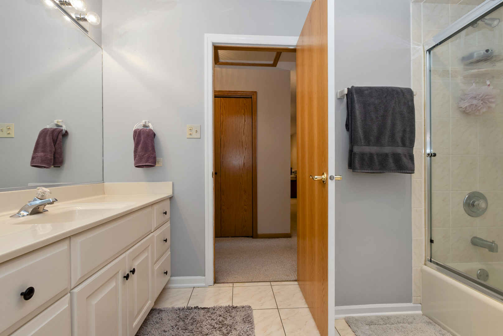 9051 Archer Avenue Willow Springs, IL 60480 - Photo 17 of 30 a bathroom with a shower sink and mirror