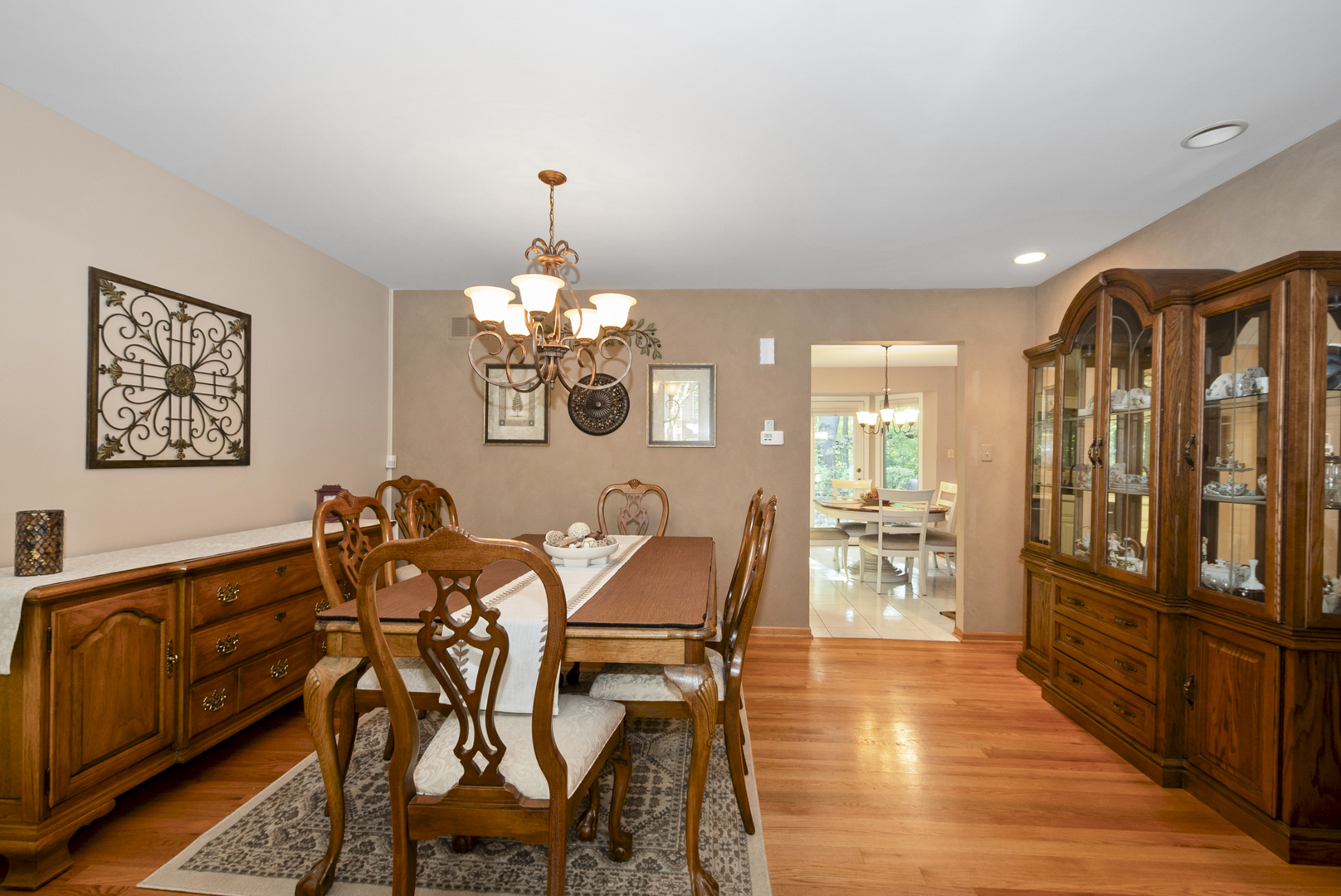 9051 Archer Avenue Willow Springs, IL 60480 - Photo 8 of 30 a view of a dining room with furniture a chandelier and wooden floor