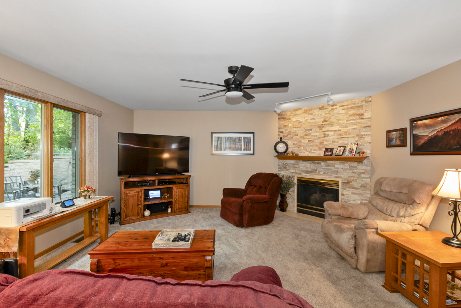9051 Archer Avenue Willow Springs, IL 60480 - Photo 10 of 30 a living room with furniture a flat screen tv and a fireplace