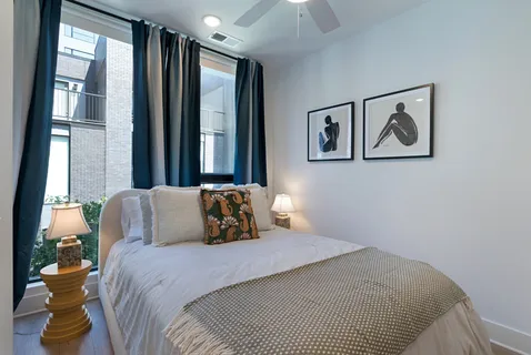 a bedroom with a bed and a lamp