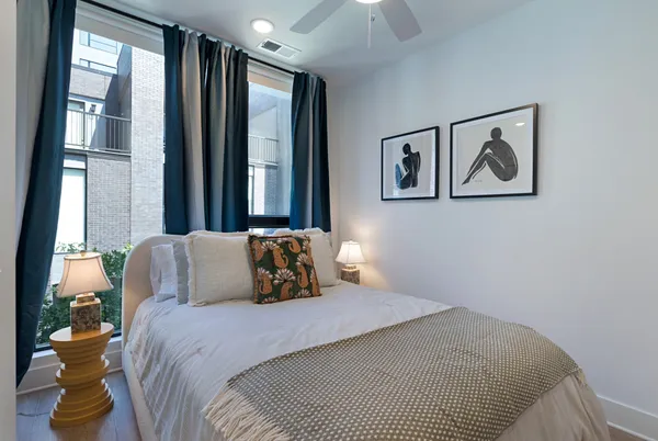 a bedroom with a bed and a lamp