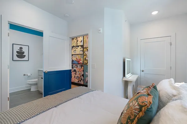 a bathroom with a sink mirror and toilet