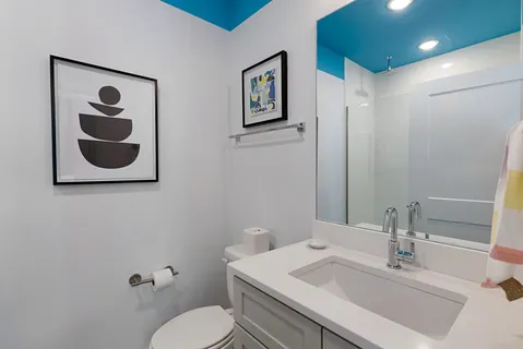 a bedroom with a bed and a painting on the wall