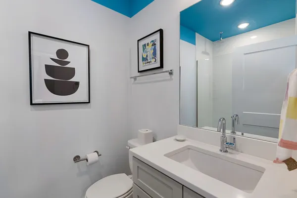 a bedroom with a bed and a painting on the wall