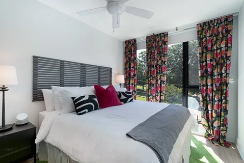 a bedroom with a bed and a painting on the wall