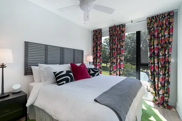 a bedroom with a bed and a painting on the wall