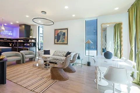 a living room with furniture and a chandelier