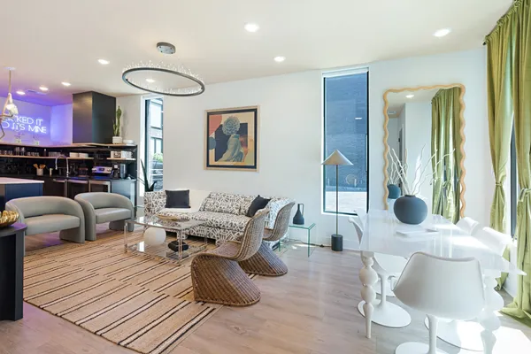 a living room with furniture and a chandelier