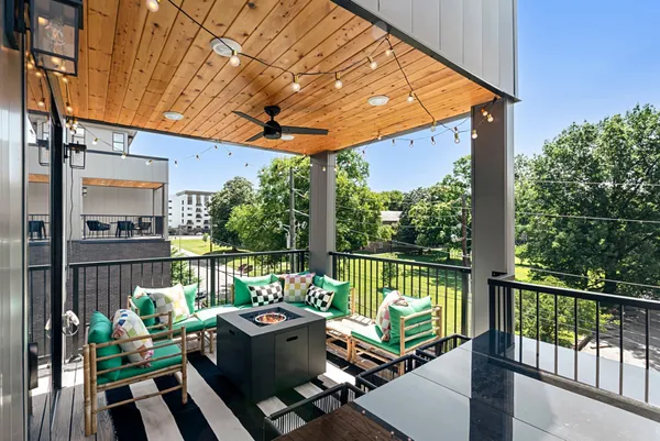 a view of a chairs and table in the balcony
