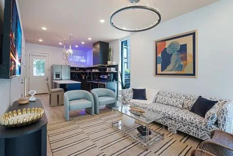 a living room with furniture and wooden floor