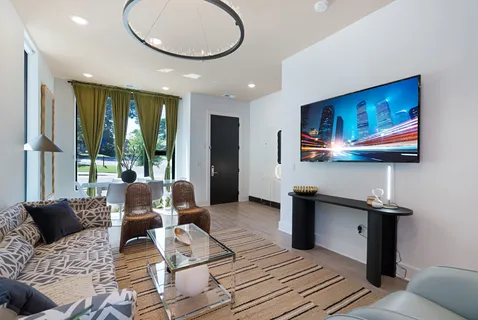 a living room with furniture and a flat screen tv