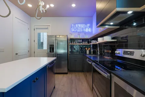 a kitchen with a refrigerator and a sink