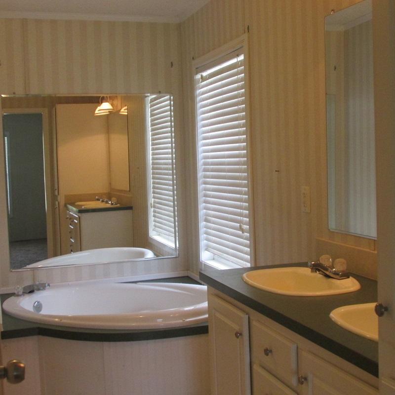 2643 Rutrough Road Southeast Roanoke, VA 24014 - Photo 13 of 32 a bathroom with a sink and a mirror