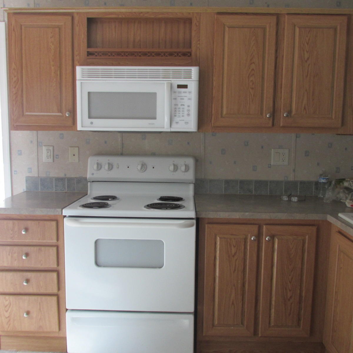 2643 Rutrough Road Southeast Roanoke, VA 24014 - Photo 19 of 32 a kitchen with a stove and a microwave