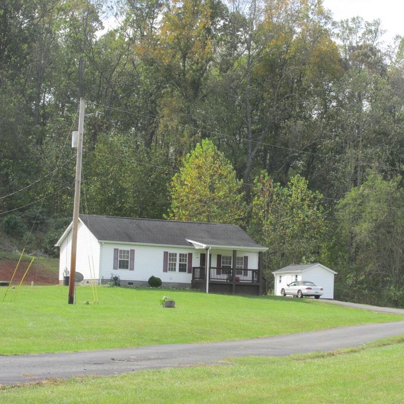 2643 Rutrough Road Southeast Roanoke, VA 24014 - Photo 7 of 32 a front view of a house with a garden and trees