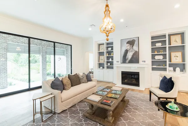 a living room with furniture a rug and a fireplace