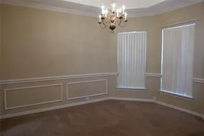an empty room with windows and fireplace