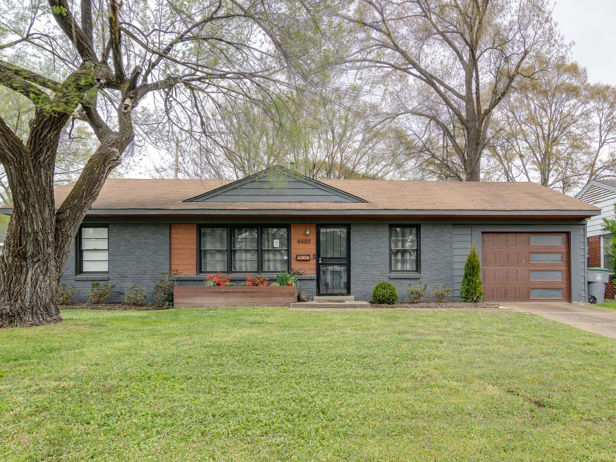 4488 Quince Road Memphis, TN 38117 - Photo 1 of 14 a front view of a house with a yard