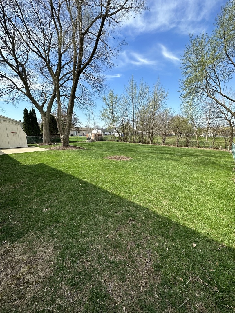 420 Iverson Lane Schaumburg, IL 60169 - Photo 2 of 12 a view of grassy field with large trees