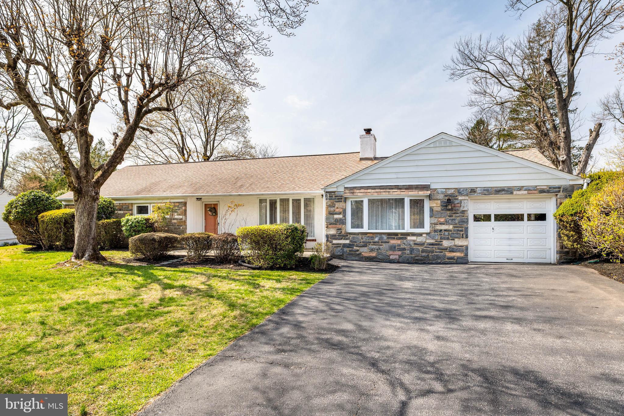a view of a house with a yard patio and fire pit