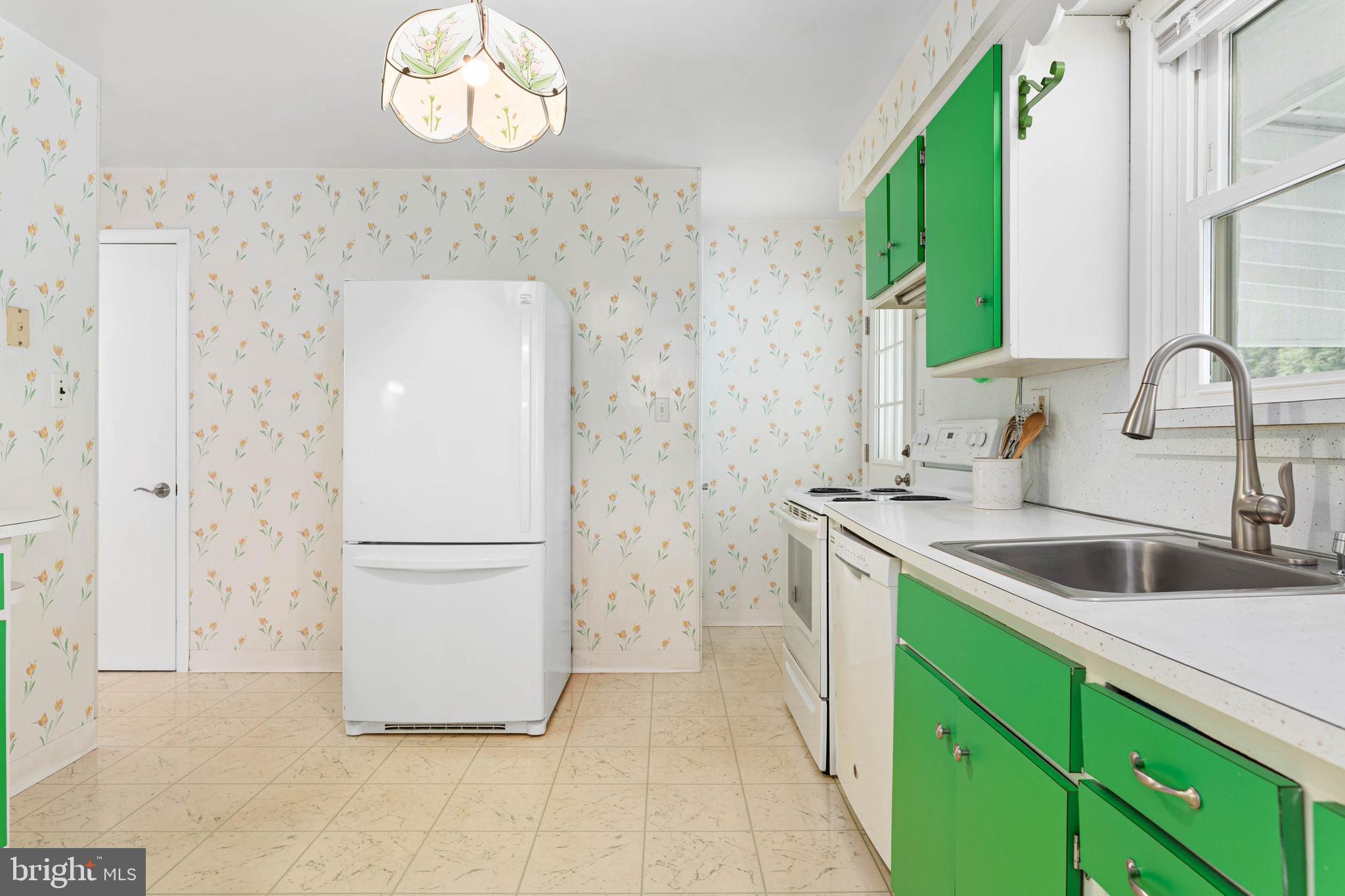 136 Ashley Road Newtown Square, PA 19073 - Photo 8 of 29 a kitchen with a refrigerator sink and cabinets
