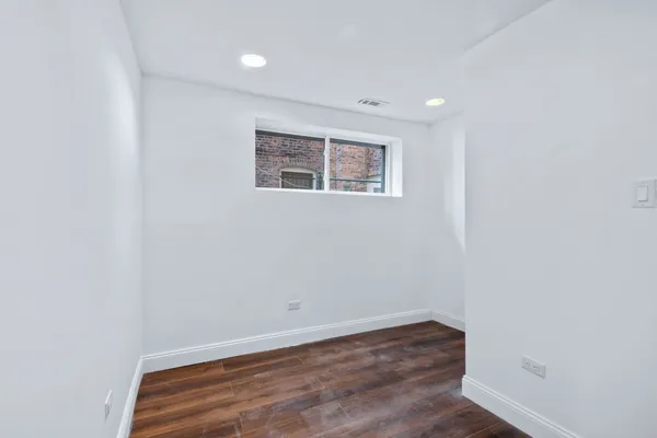 a view of a room with wooden floor