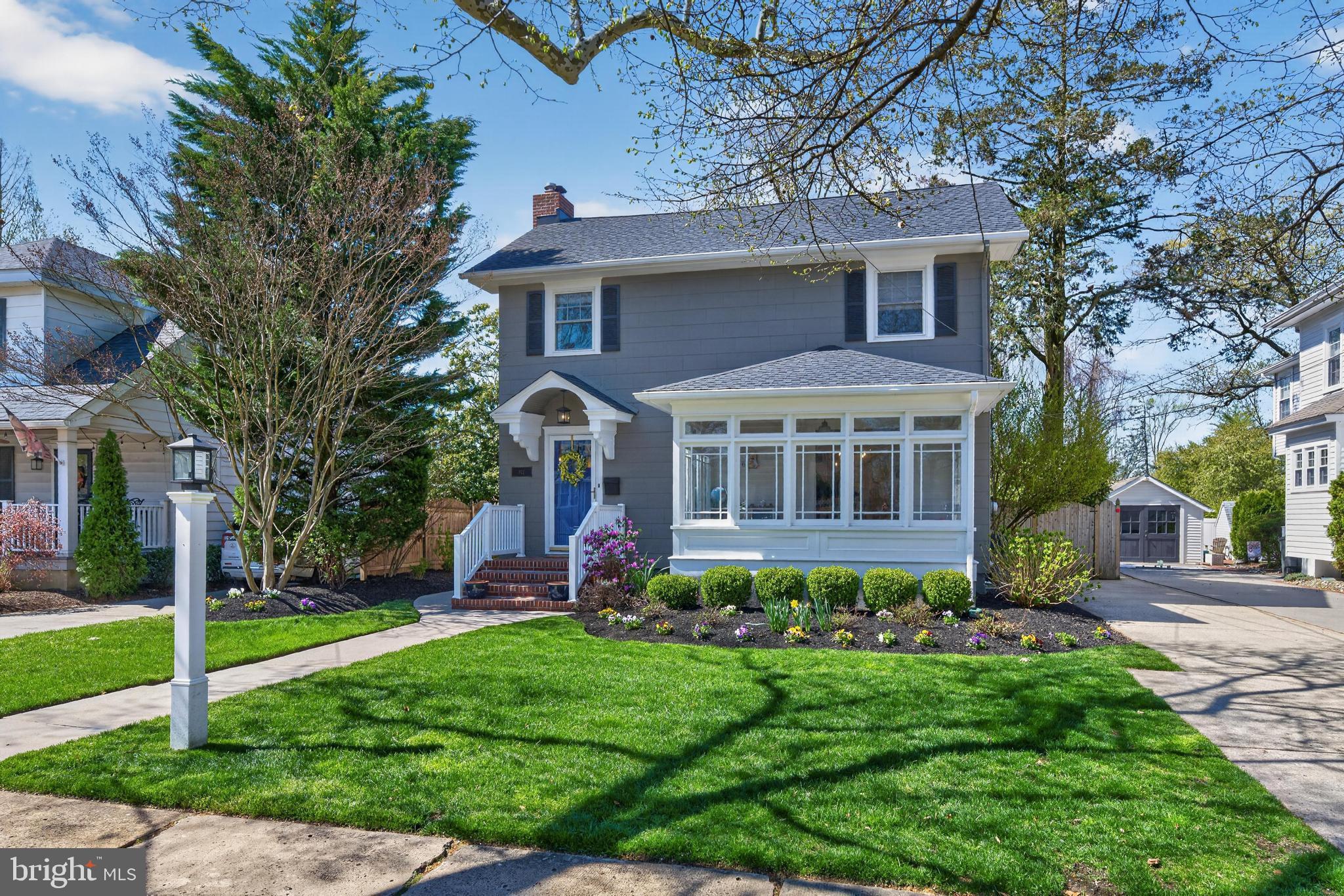 a front view of a house with a yard and porch