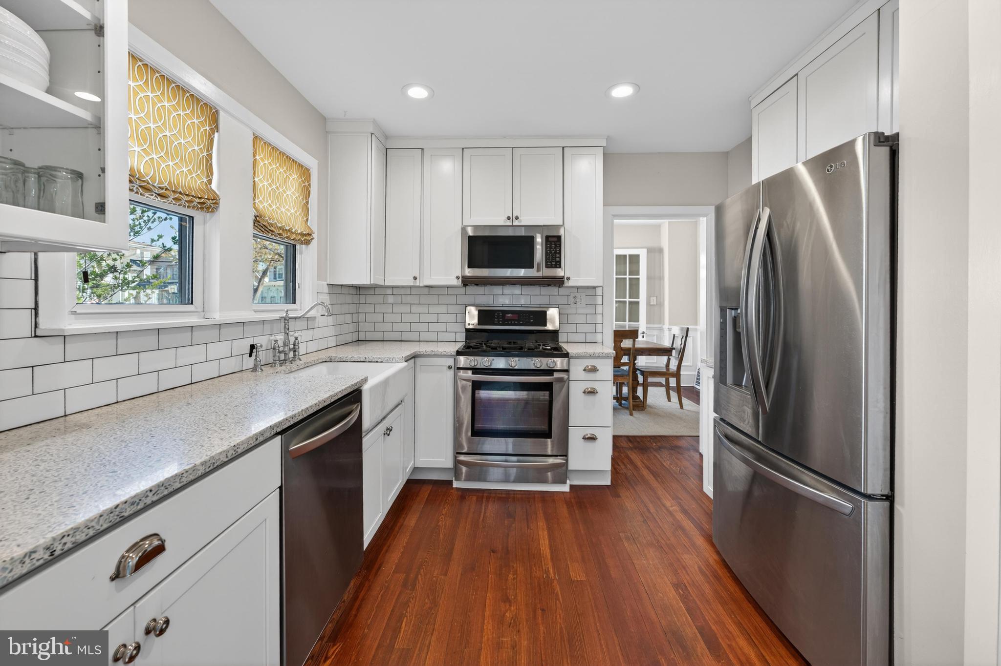 812 Princeton Avenue Haddonfield, NJ 08033 - Photo 14 of 30 a kitchen with a refrigerator stove and wooden floor