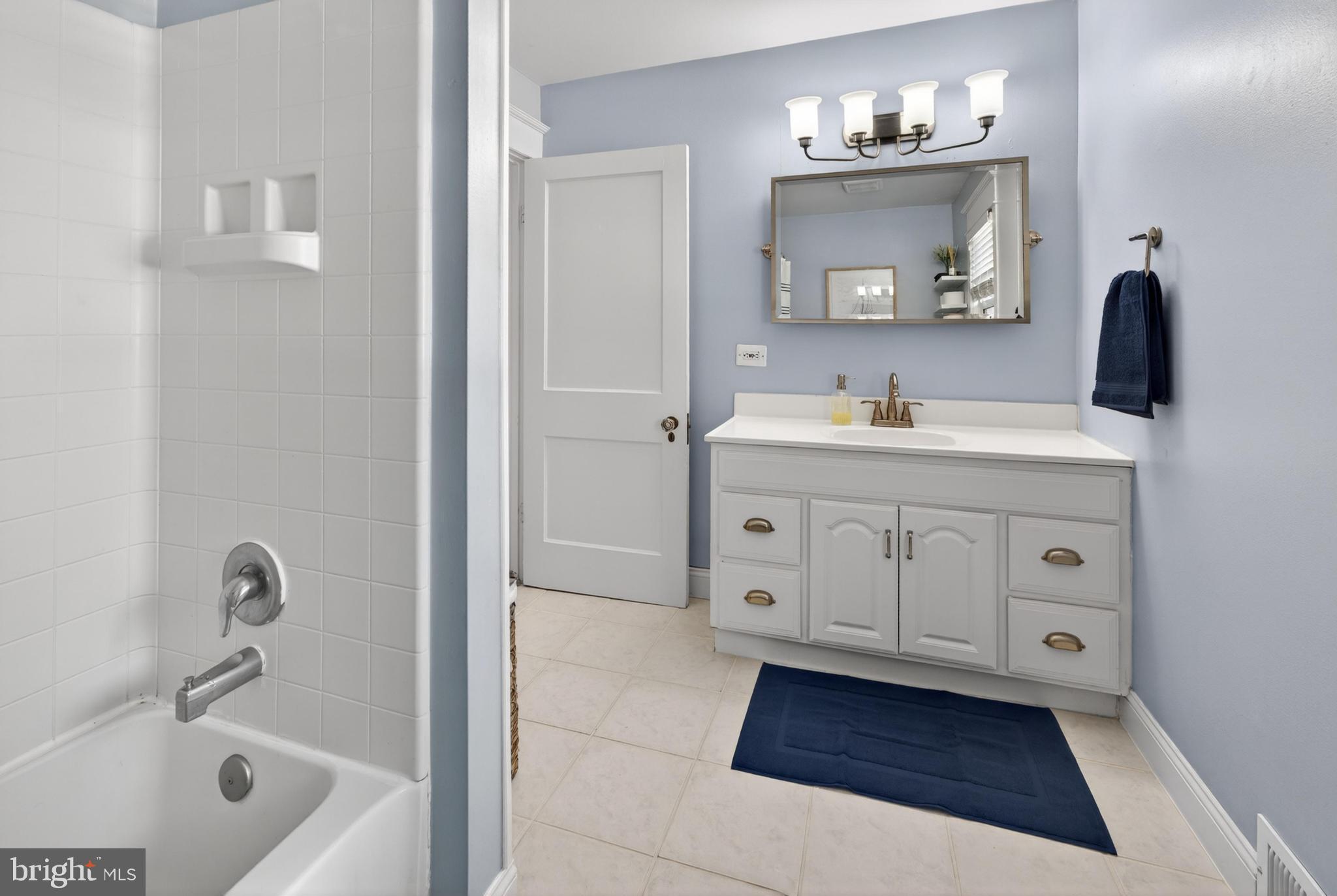 812 Princeton Avenue Haddonfield, NJ 08033 - Photo 22 of 30 a bathroom with a sink a tub and a mirror