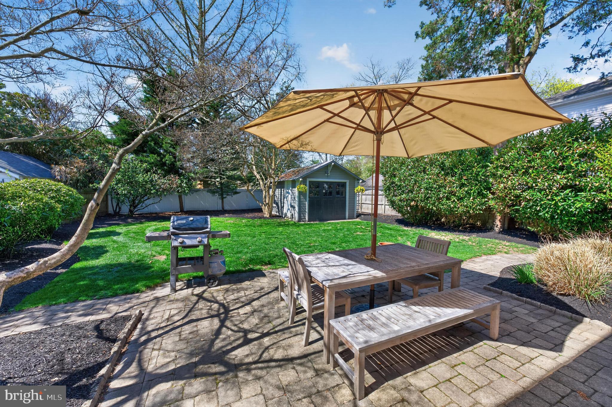 812 Princeton Avenue Haddonfield, NJ 08033 - Photo 27 of 30 a view of a patio with table and chairs under an umbrella