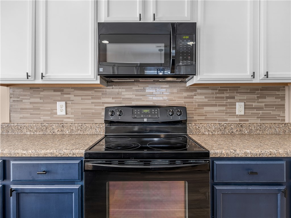 2520 Linmar Circle Anderson, SC 29621 - Photo 17 of 50 A sleek black range with a coordinating microwave offers essential kitchen functionality.