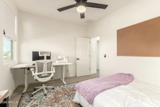 a bedroom with a large bed and a chandelier