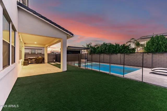 a large kitchen with stainless steel appliances a stove a sink a center island and a wooden floor