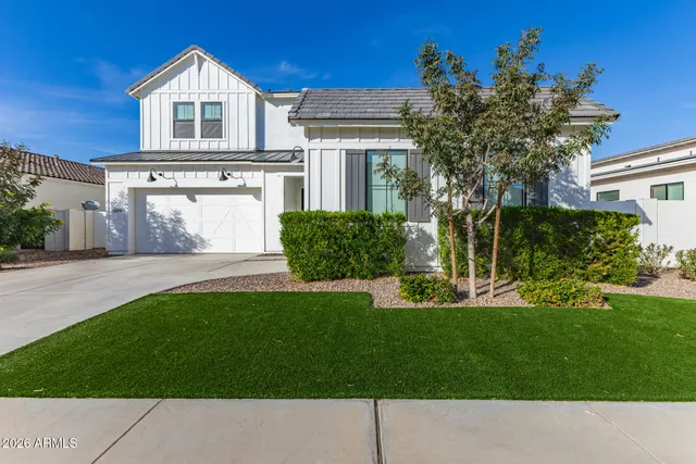 a view of a hallway with wooden floor and a bathroom