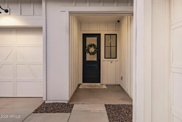 a view of staircase with lots of frames on wall and wooden floor